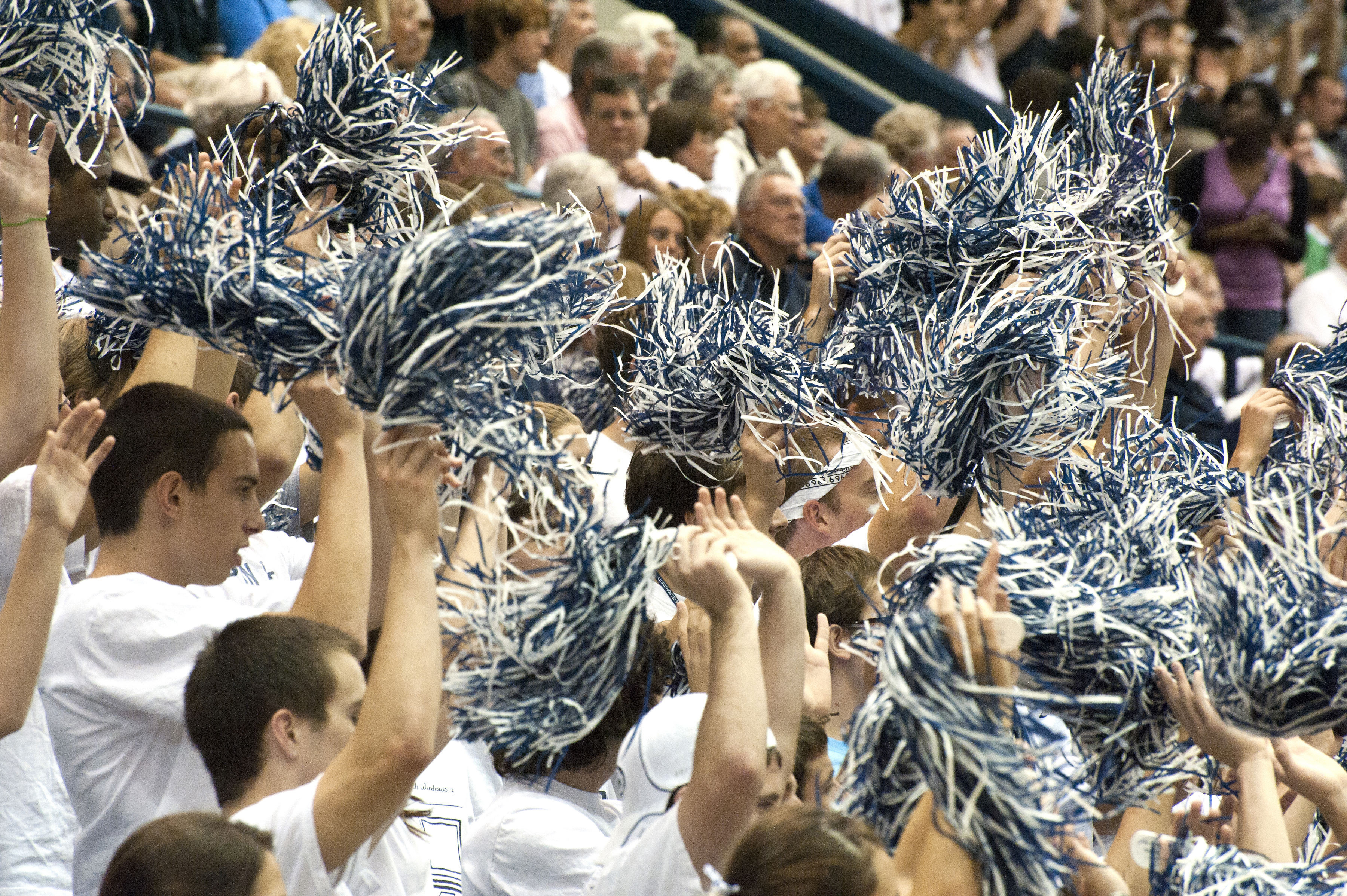 Penn State fans wave blue and white pom-poms.