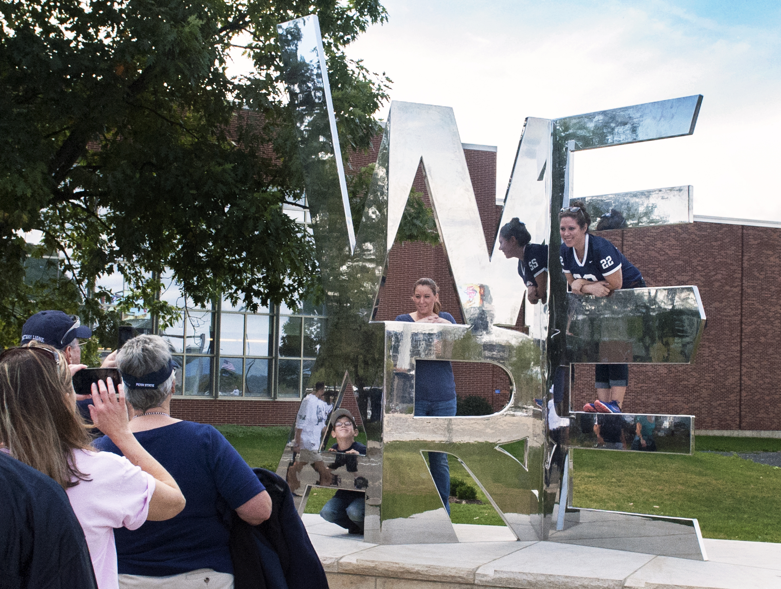 Visitors taking photos at the We Are sculpture