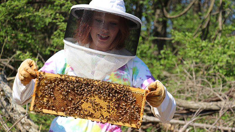 student with beehive