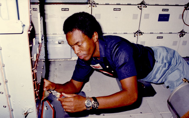 Astronaut Guy Bluford works while floating in a space shuttle