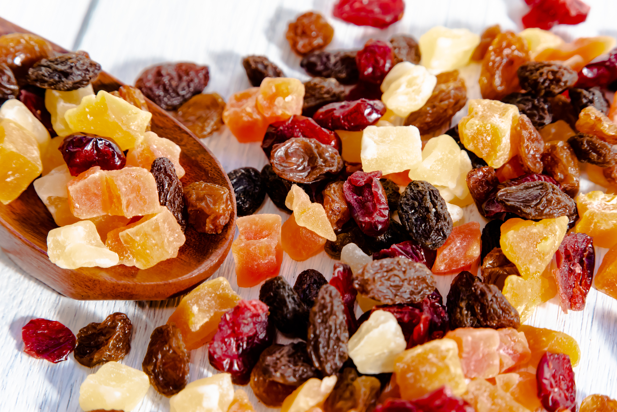 A variety of dried fruit mix spilled on a table