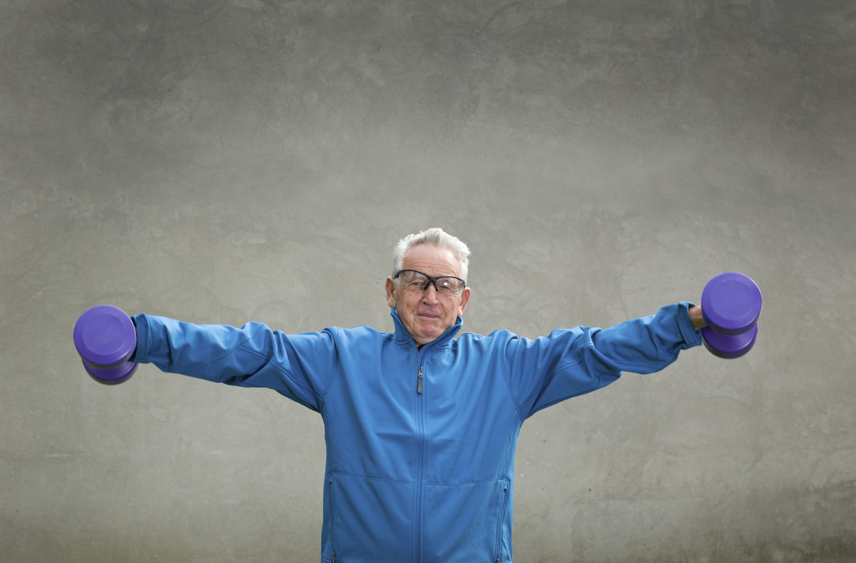 elderly man using barbells