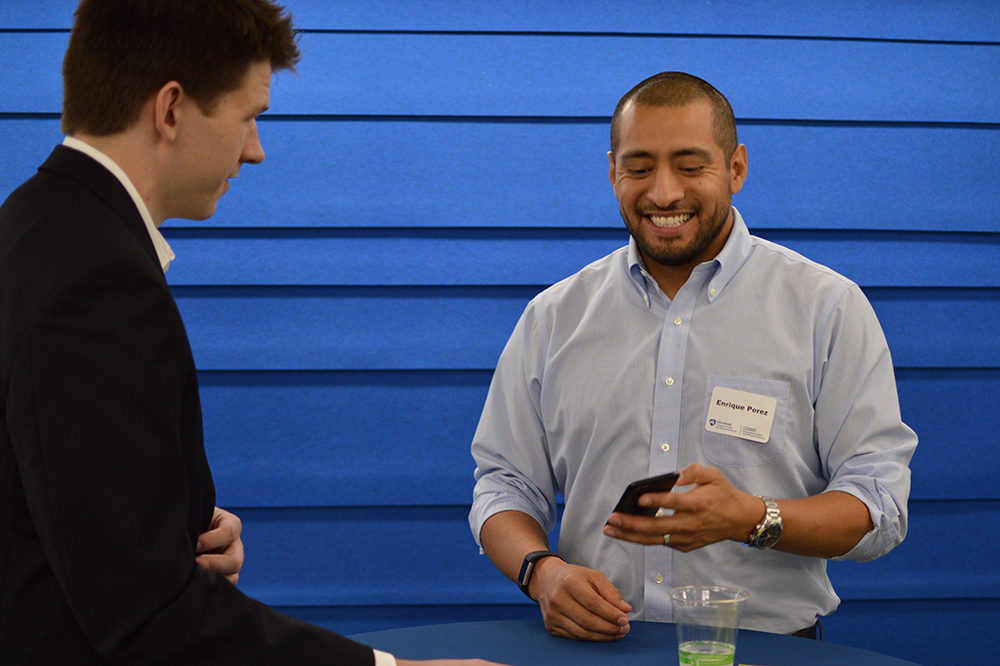 Enrique Perez chatting with student at mentoring program kickoff