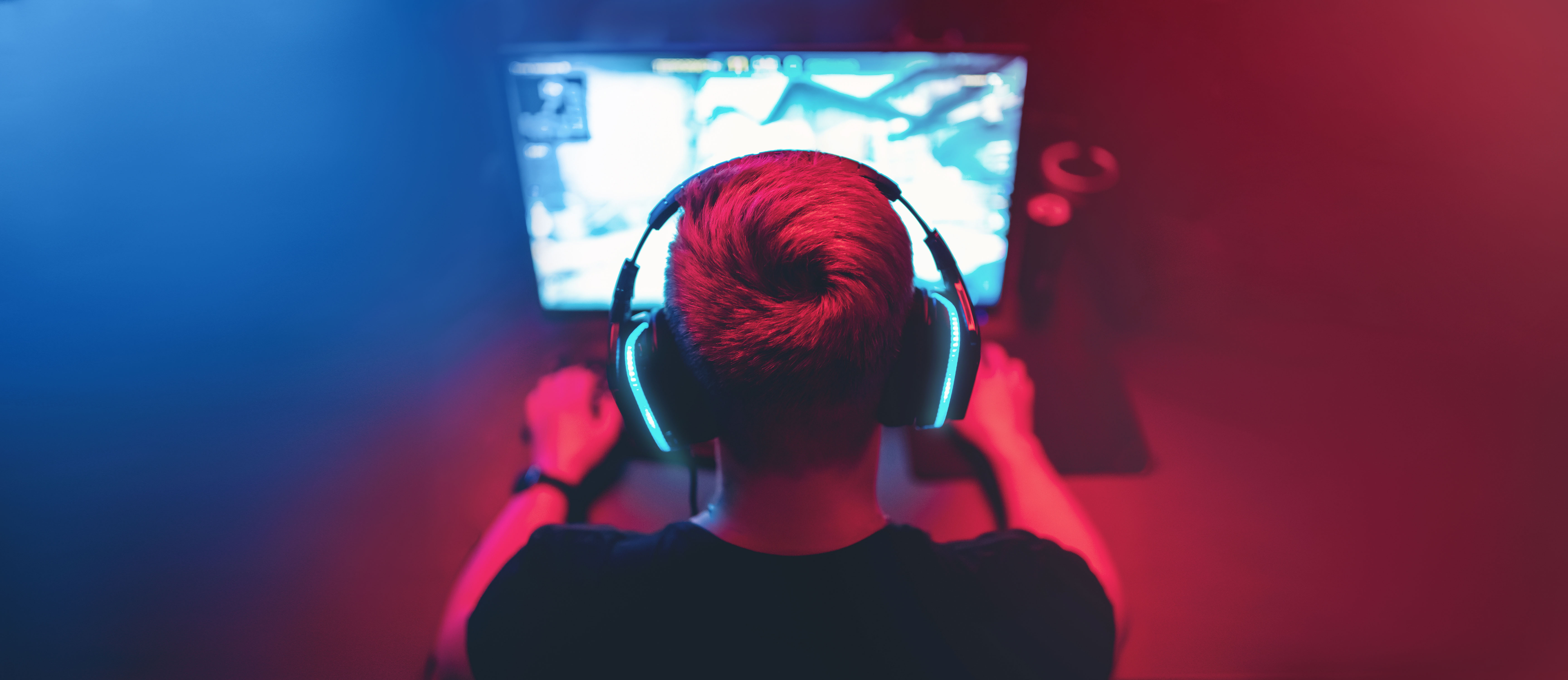 A young man plays an online game on the computer