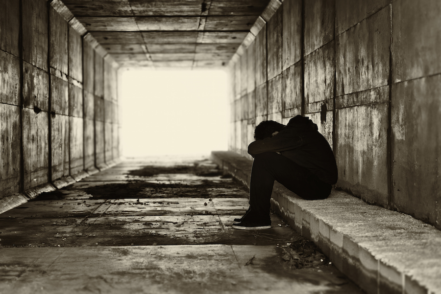 Silhouette of a teen in a tunnel