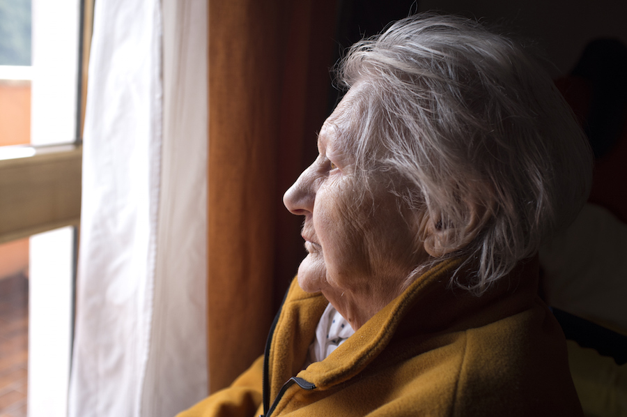 Older woman looking out window