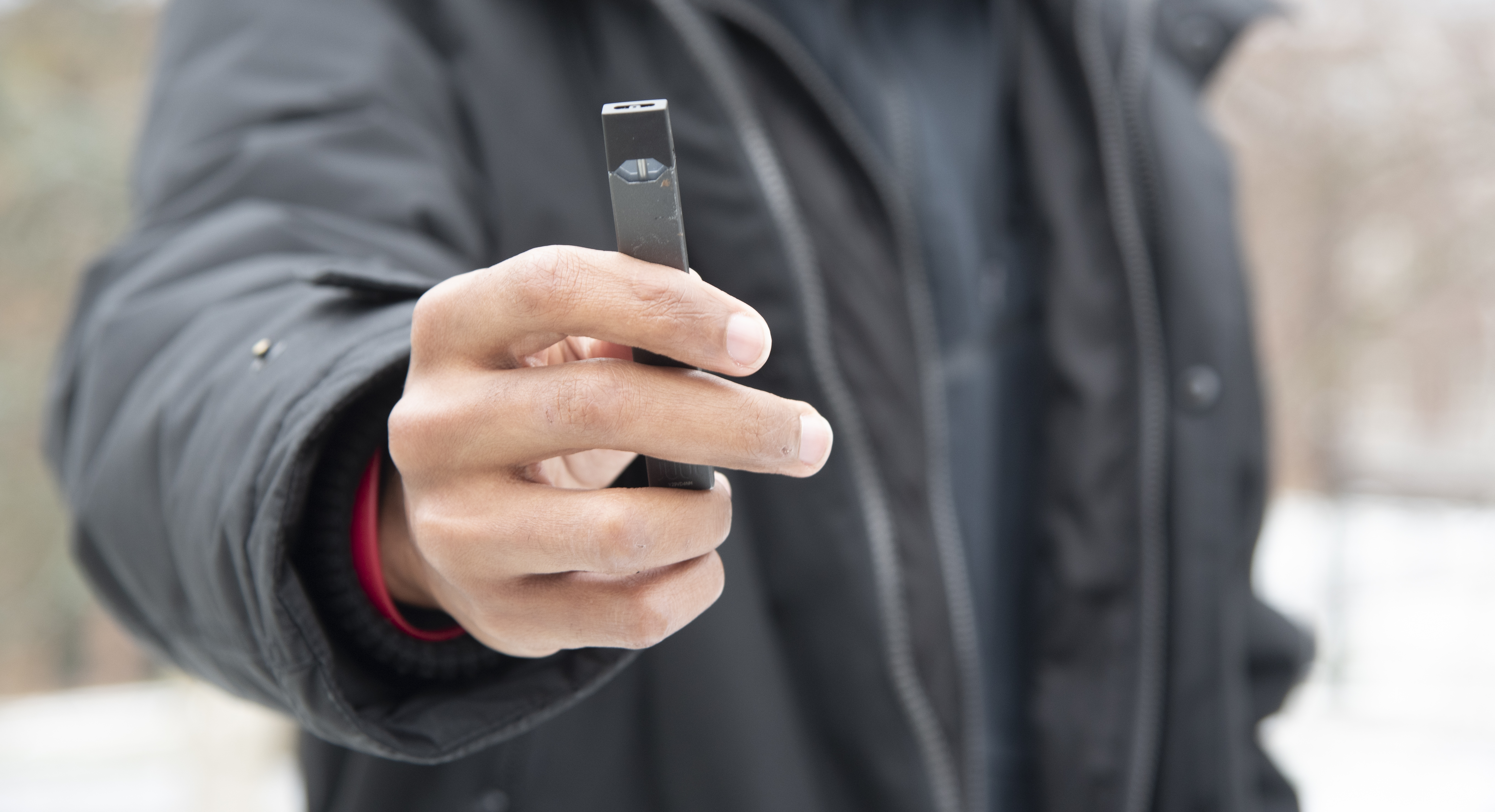 Student holding a Juul pen