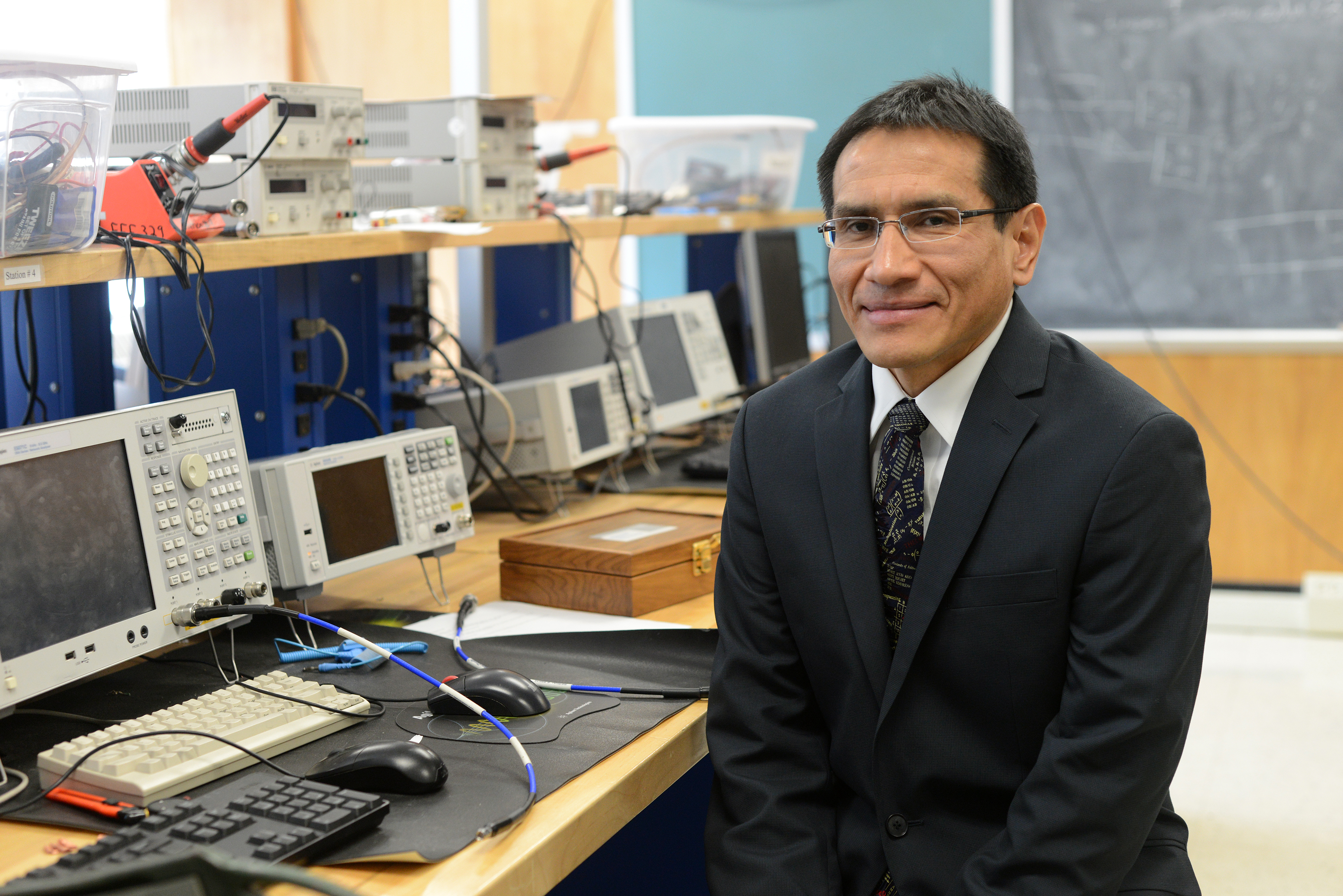 Julio Urbina sitting in lab