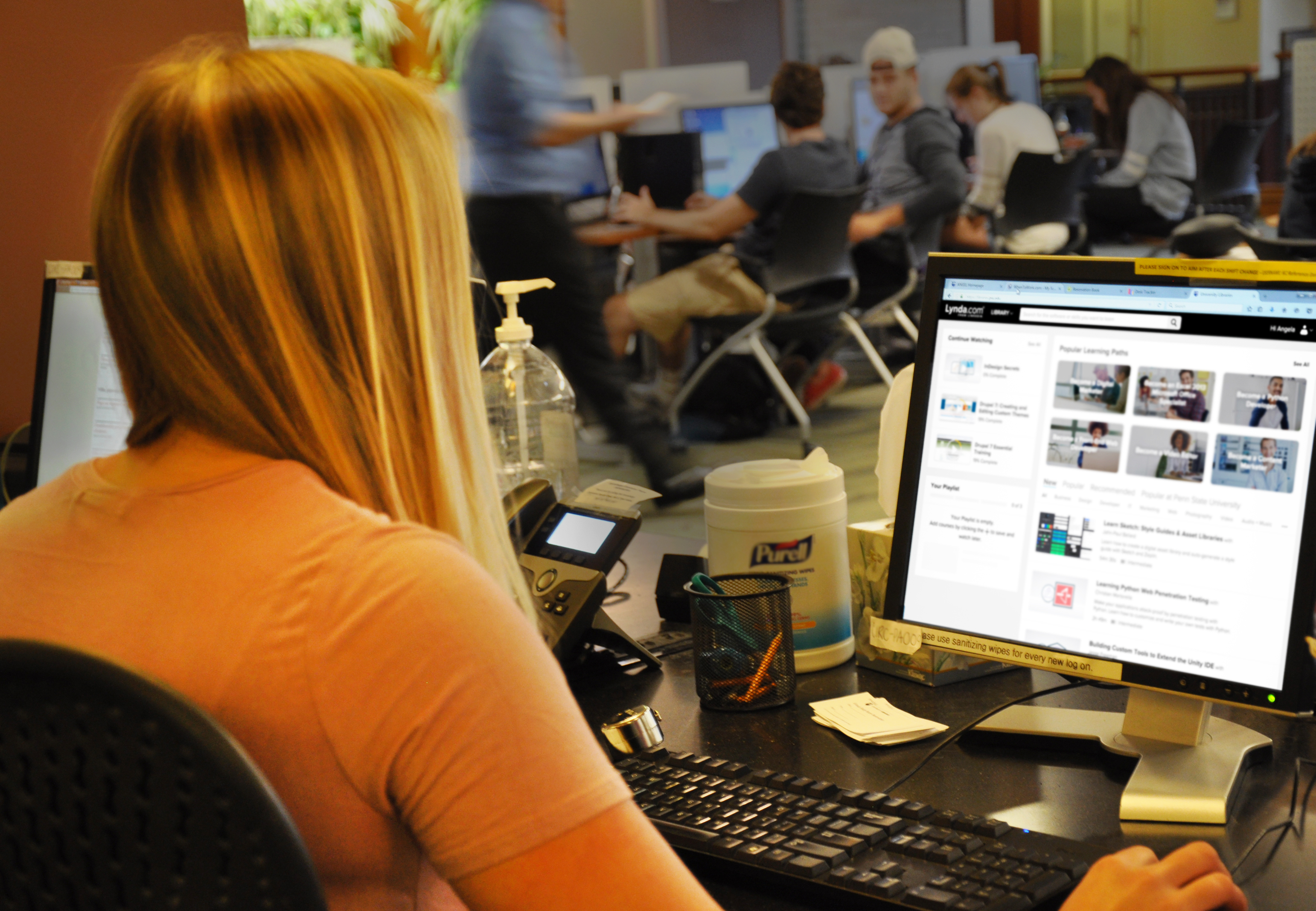 A student sits at a desk on her computer