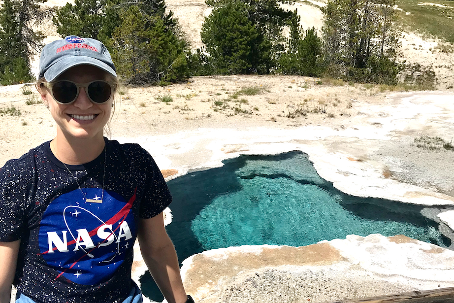 Rachel Kronyak poses next to a hot spring in Yellowstone National Park 