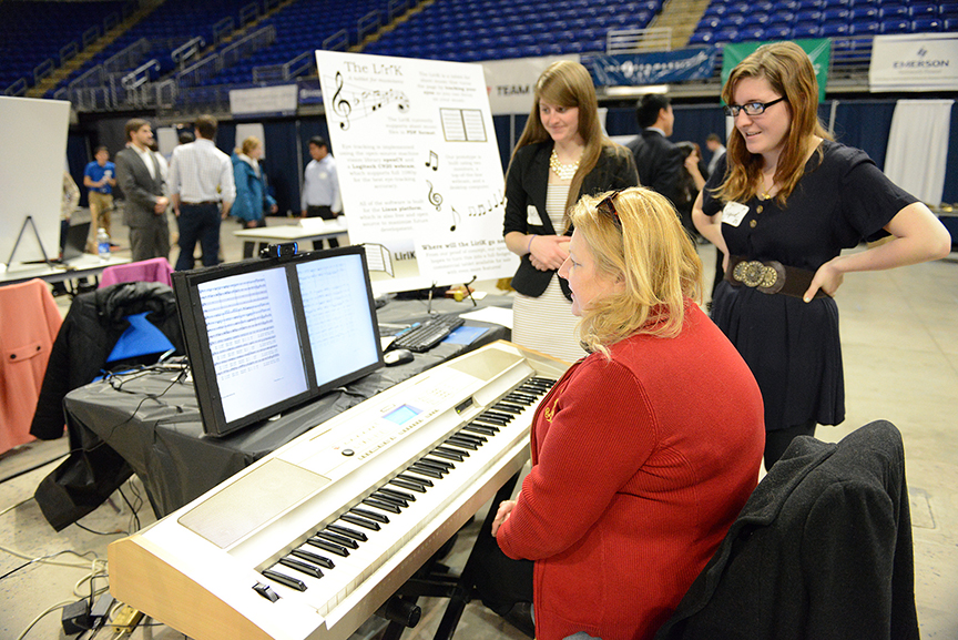 Students demonstrate the "LiriK," a tablet for sheet music that turns the page by tracking a person's eyes.