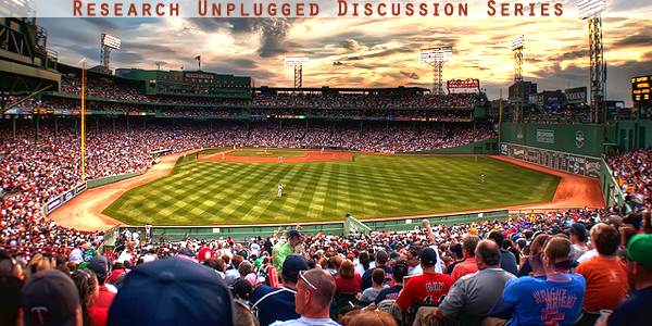 crowd watching baseball game at dusk