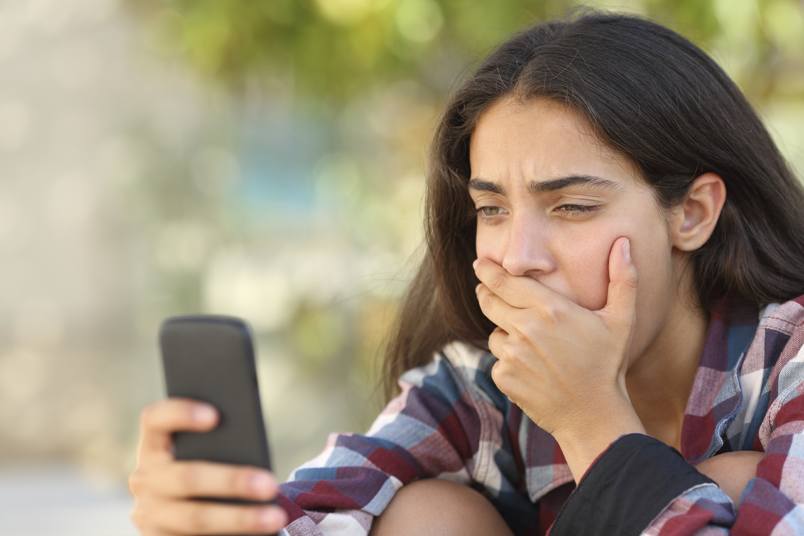 shocked teen looking at phone