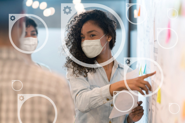 Circle icons overlay a photo of a person wearing a mask pointing at a board