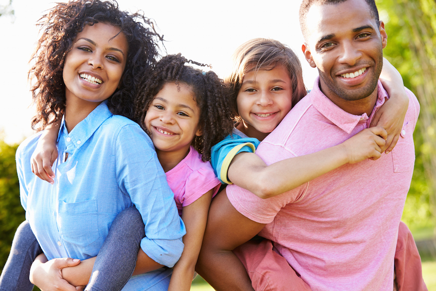 Parents Giving Children Piggyback Rides