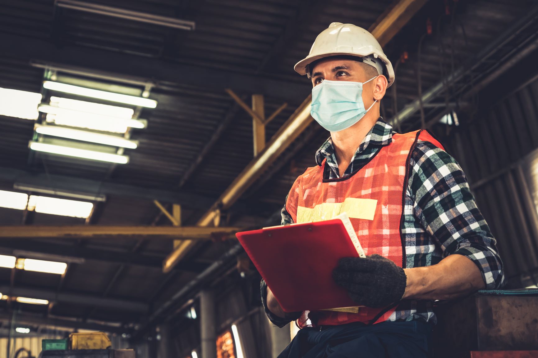 Factory worker with face mask protecting from outbreak of COVID-19.