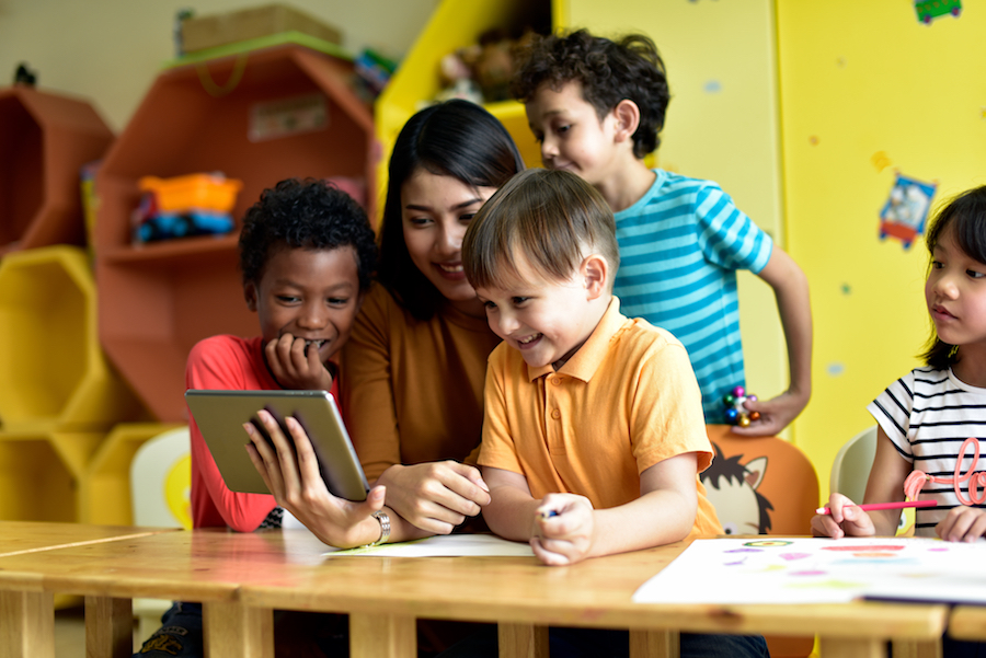 Children and teacher having fun learning