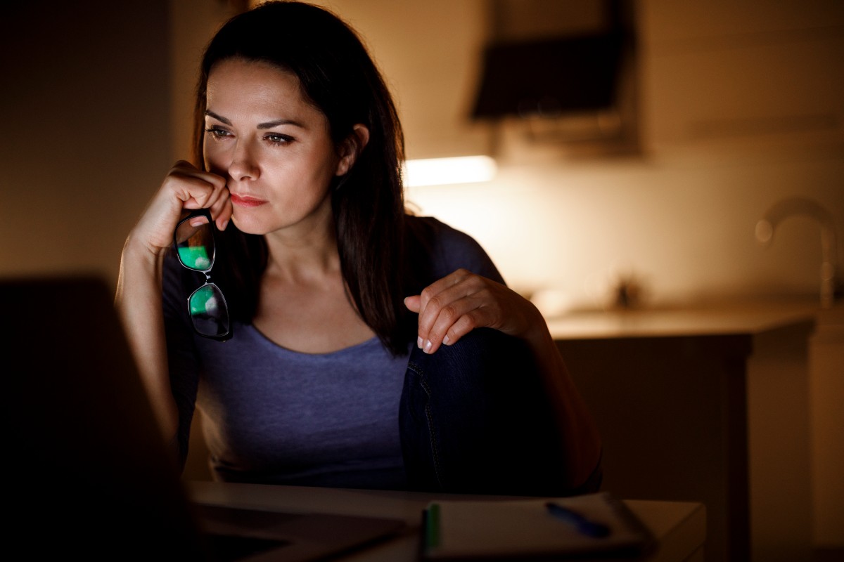 A woman looks at her computer