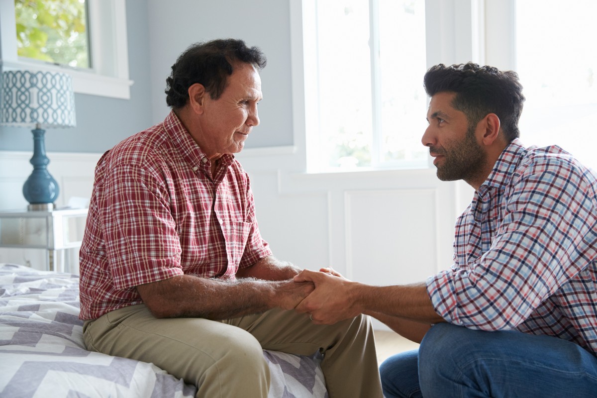 An adult son has an end of life care discussion with his elder father. 