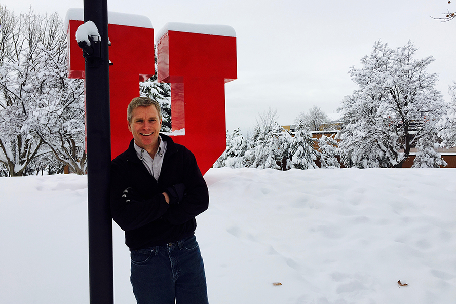 Jim Steenburgh standing next to University of Utah "U" statue