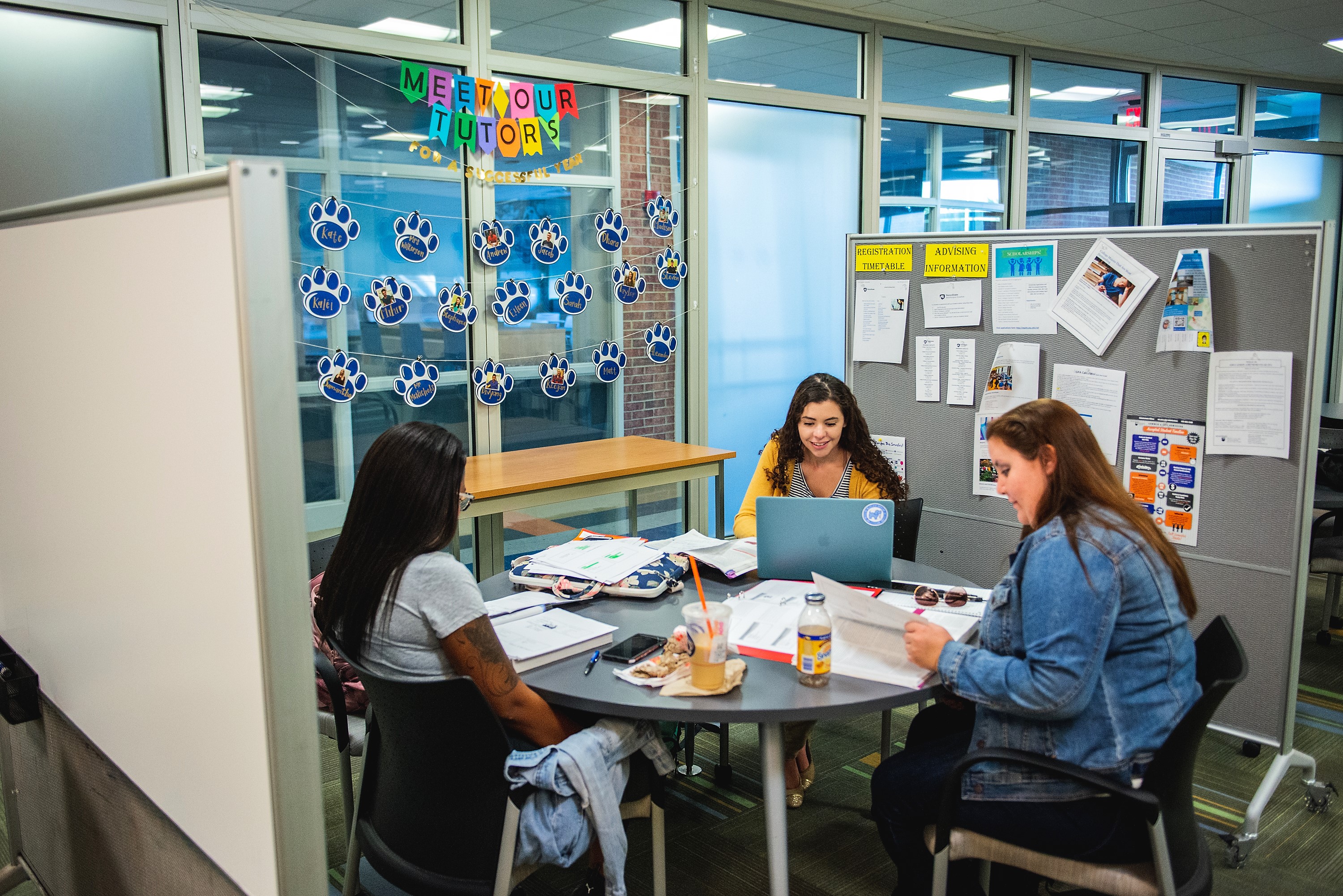 student tutors at table working in the learning center