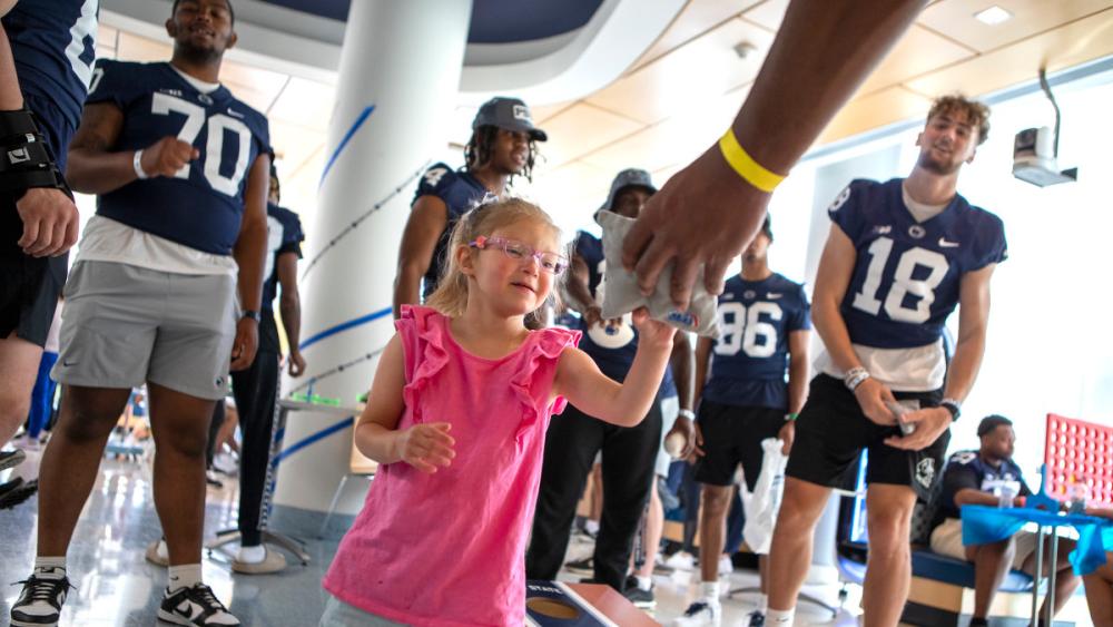 Penn State football players put smiles on faces during Children’s