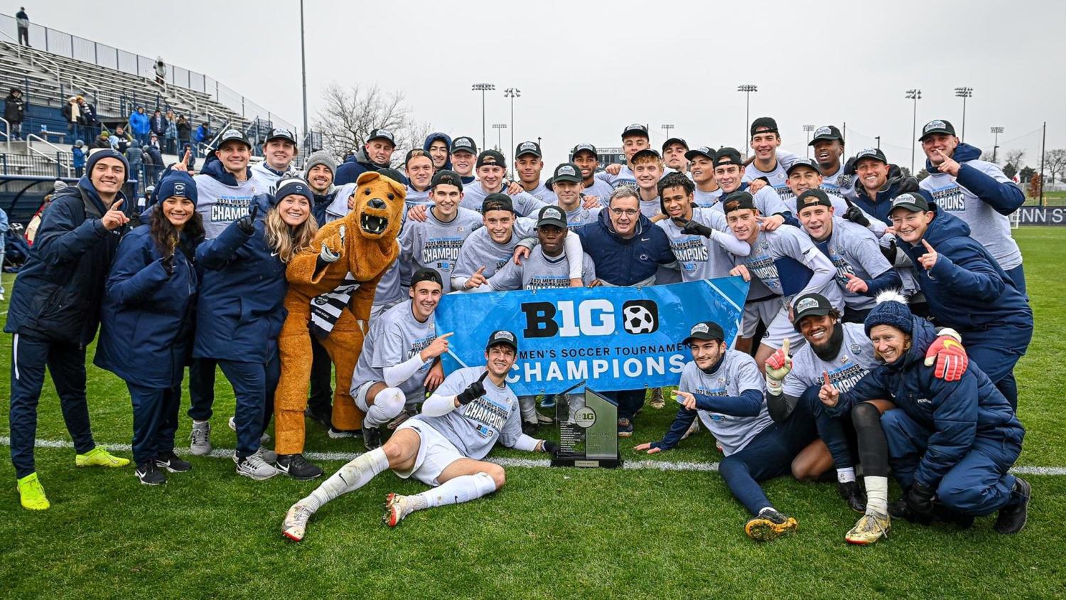 Soccer team poses with Big Ten tournament championship banner