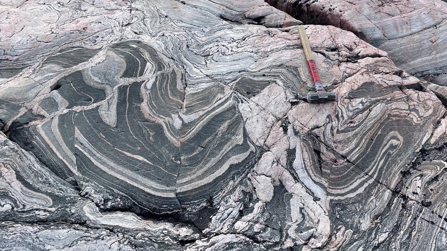 Metamorphic rocks with a hammer on top