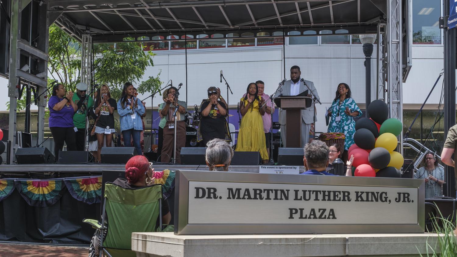 A colorful stage with performers in the Martin Luther King Plaza