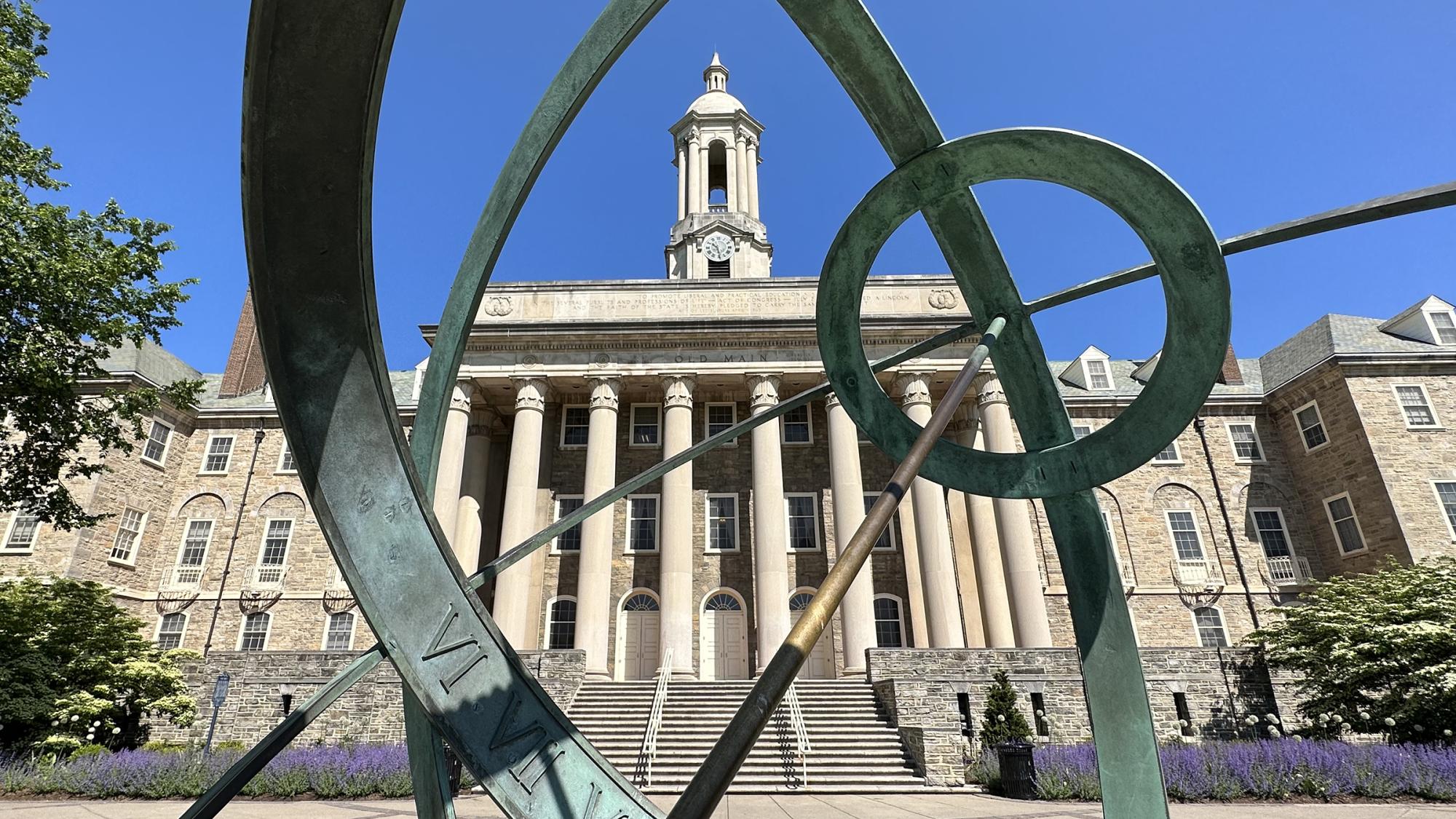 Wide shot of Old Main through Armillary Sphere