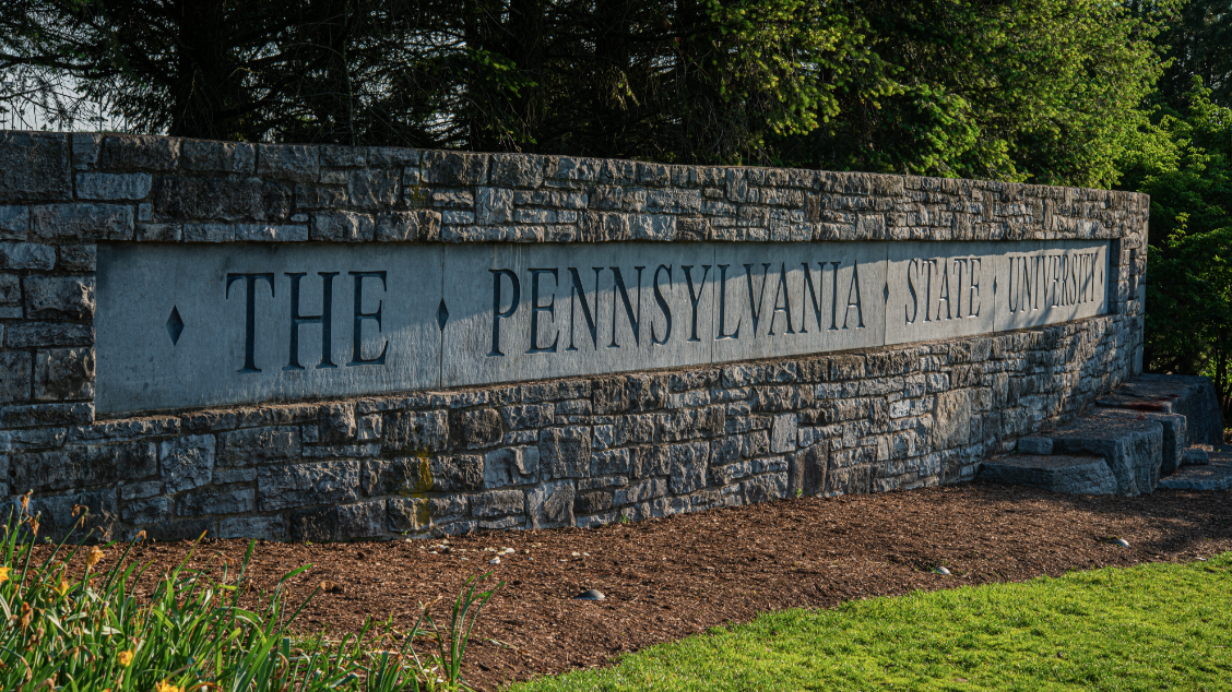 Stone wall with "THE PENNSYLVANIA STATE UNIVERSITY" written on it
