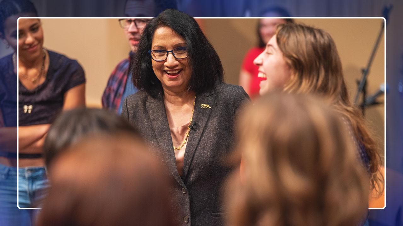 A candid photo of Neeli Bendapudi laughing with students.