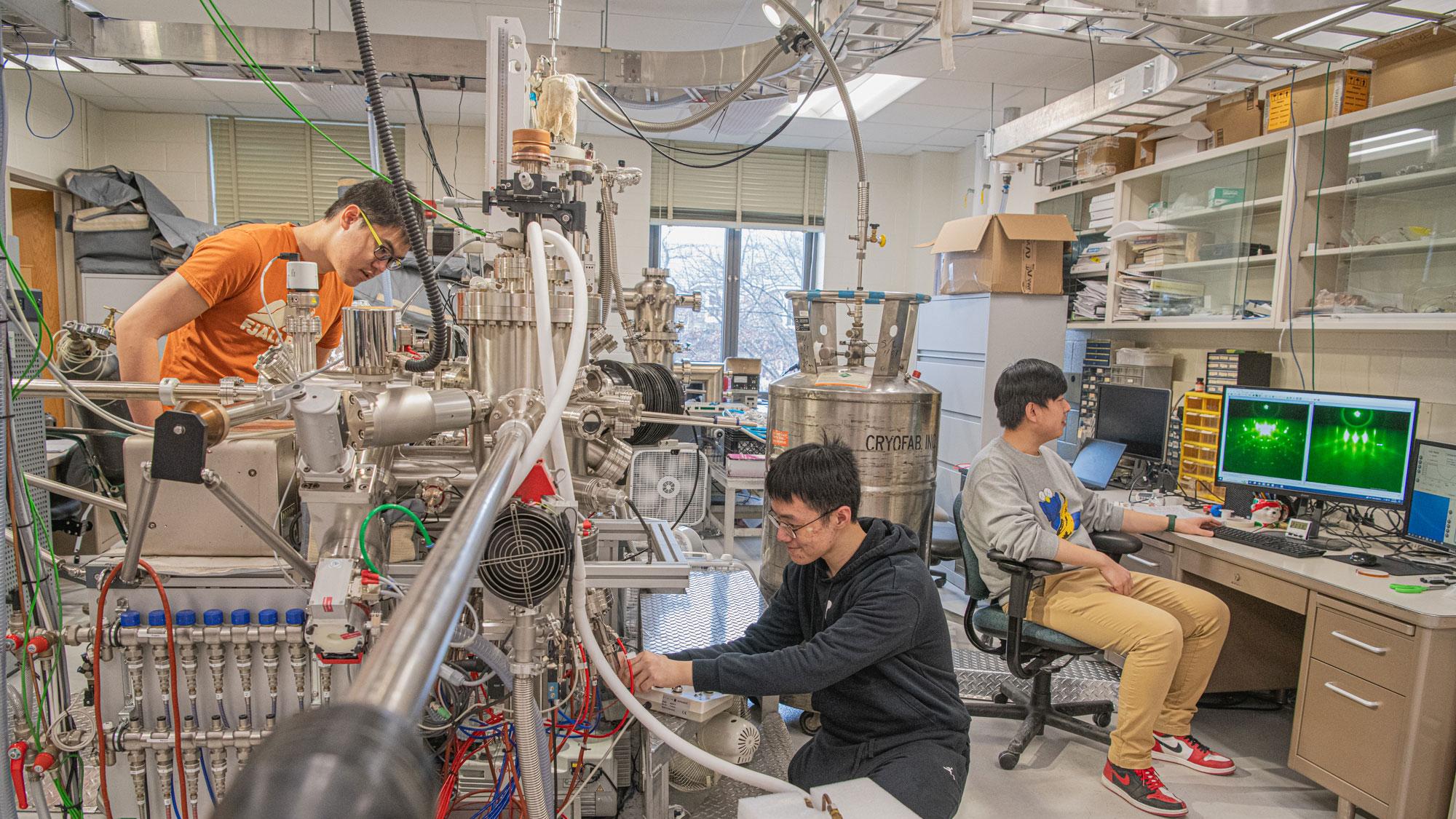 Han Tay, Pu Xiao, and Jie Yan operate a large piece of equipment