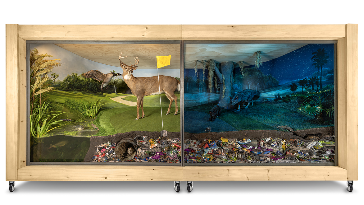 Large sculptural diorama of a golf course in the day at night