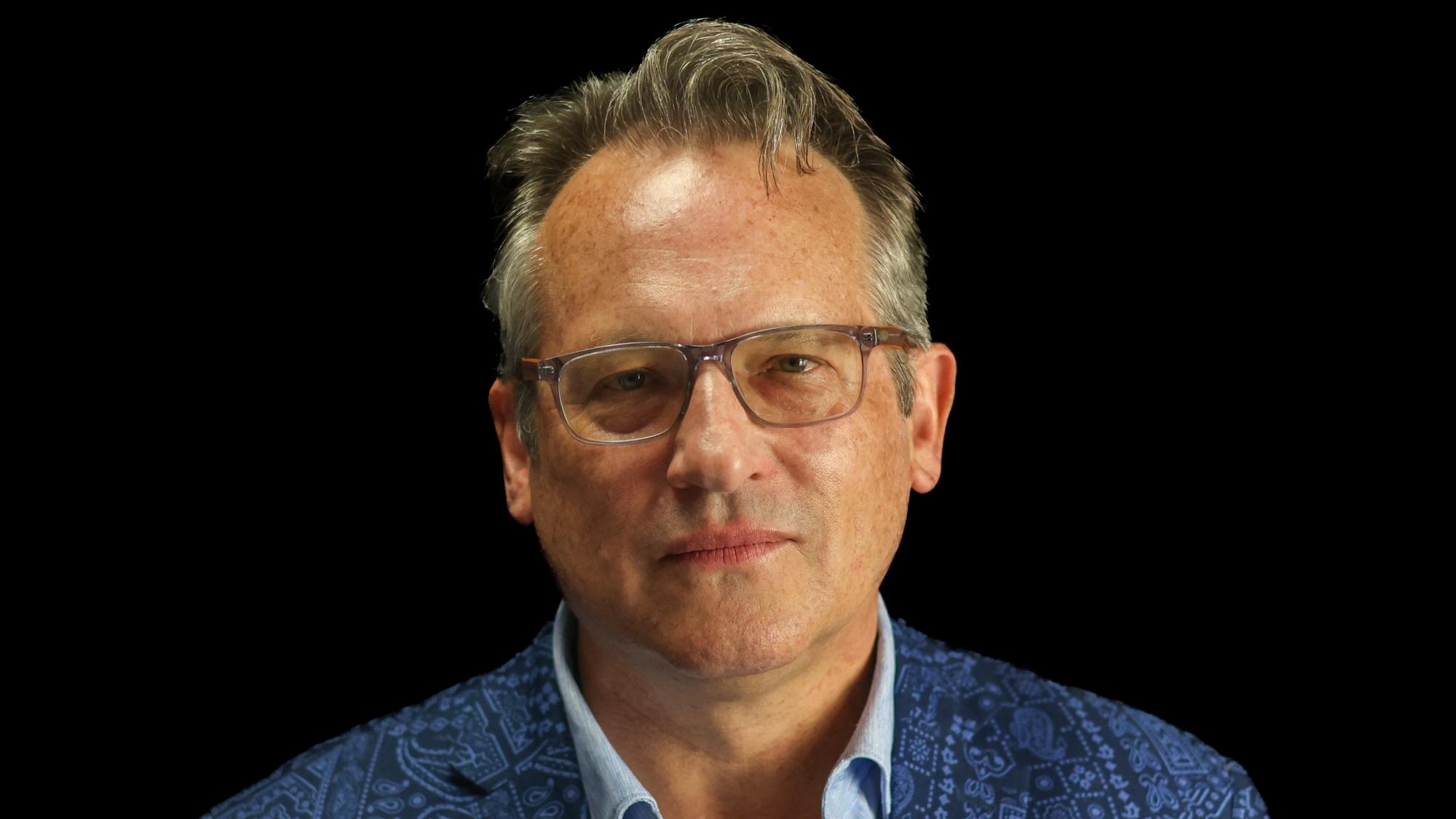 Matthew Restall wears a blue paisley jacket and blue shirt