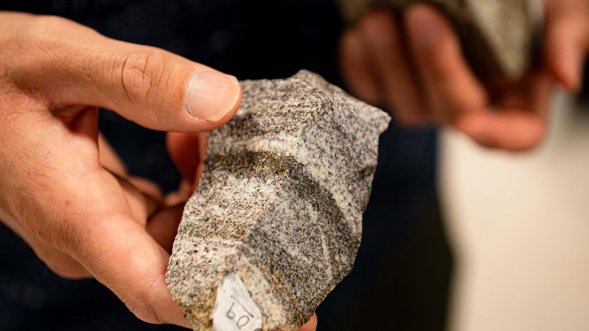A hand holding a rock