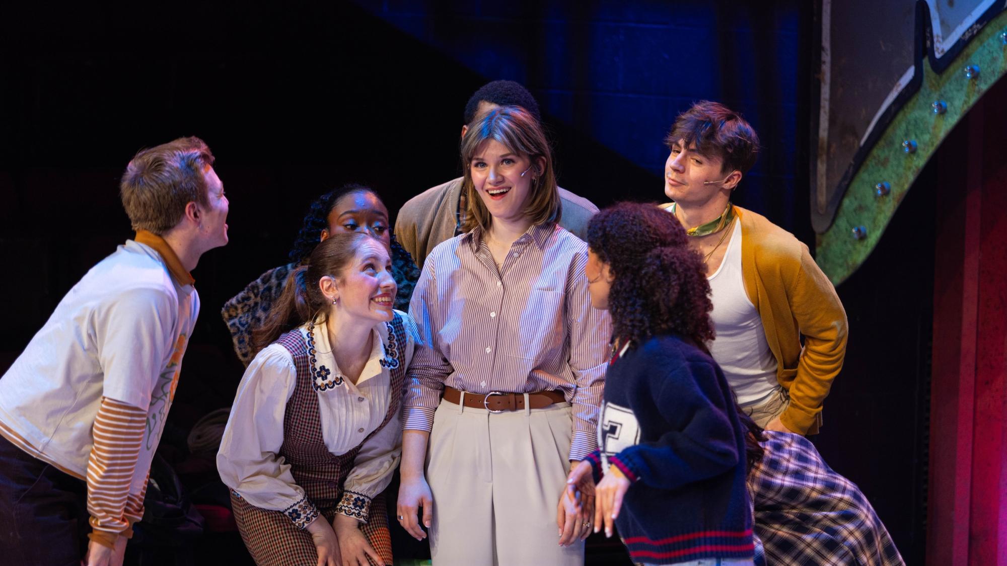 Group of young people performing in a musical