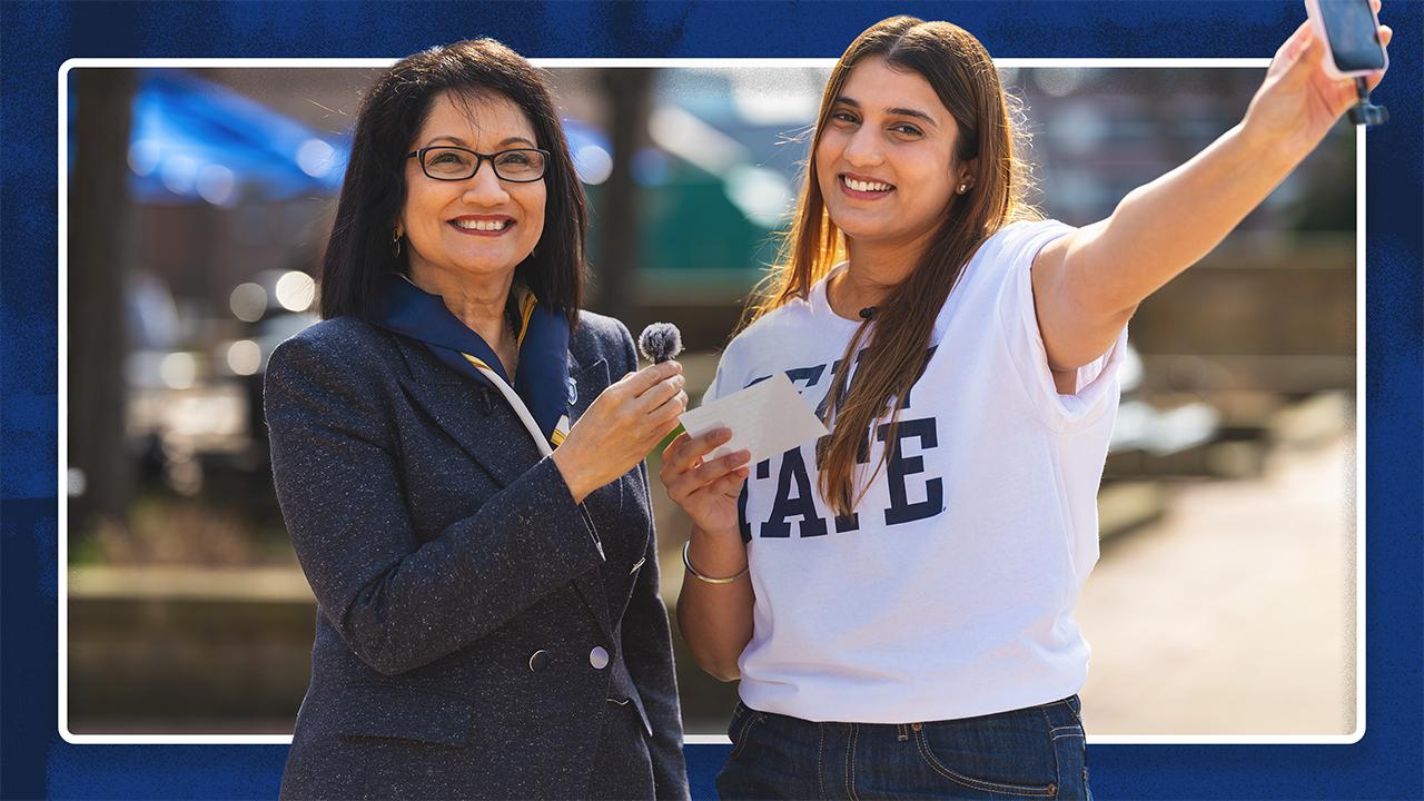 Neeli Bendapudi (left) and student Kavishi Halwavala stand together and Neeli is holding a mic and Kavishi is holding a cell phone.