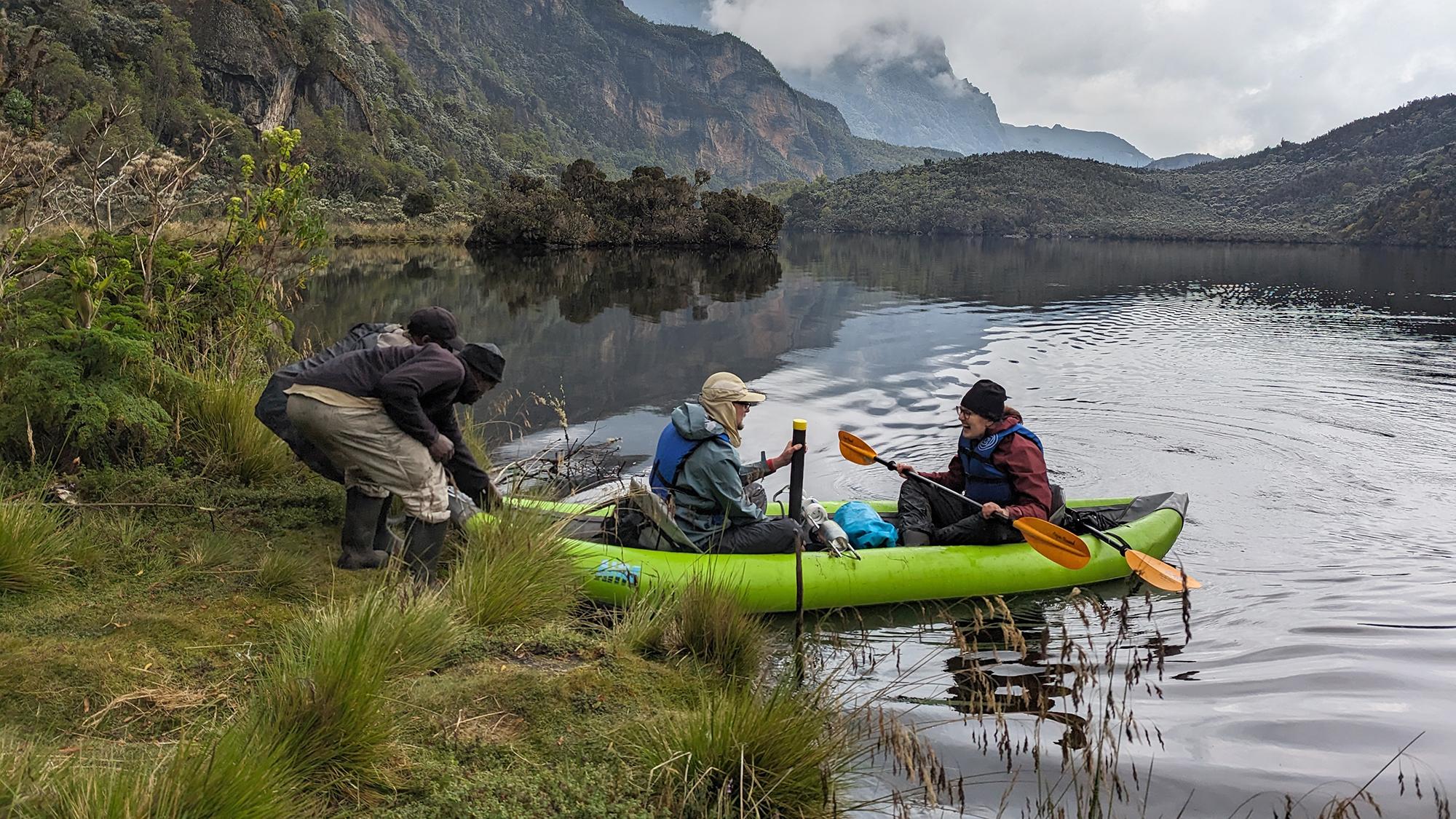 Graduate students on a boat collecting core samples