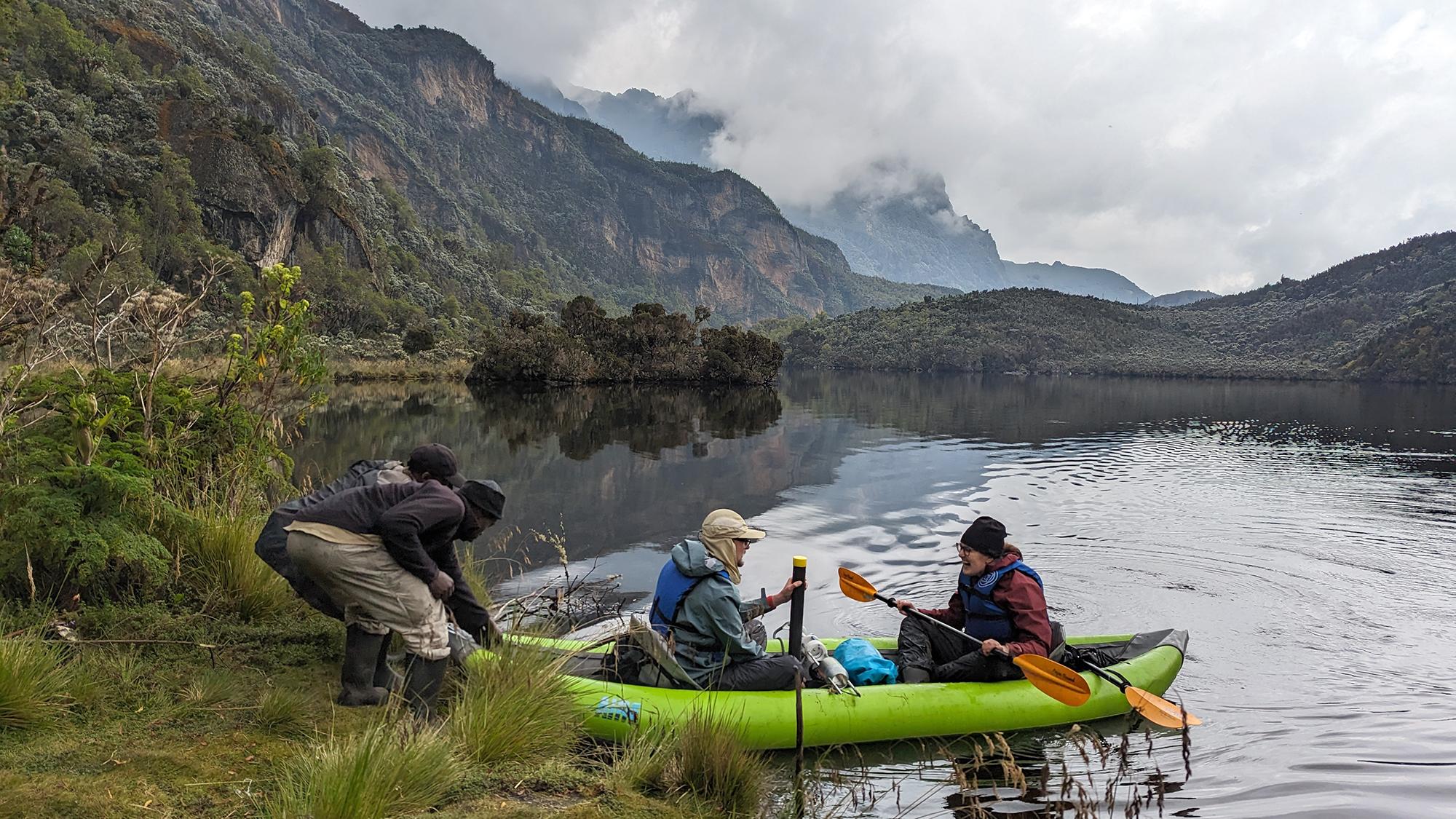 Graduate students on a boat collecting core samples