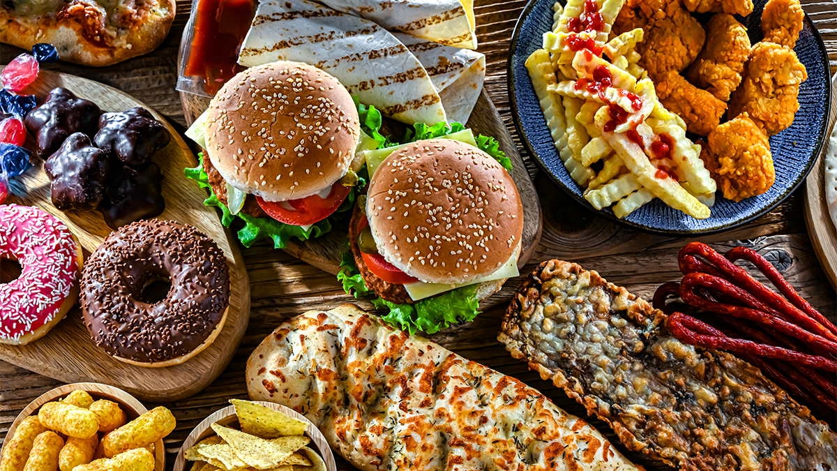Assortment of burgers, fries, donuts and other junk food
