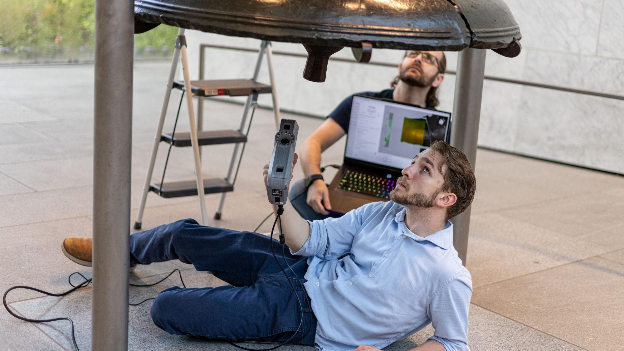 Penn State Behrend alumnus Remington Orange scans the Liberty Bell during a two-day research trip in June.