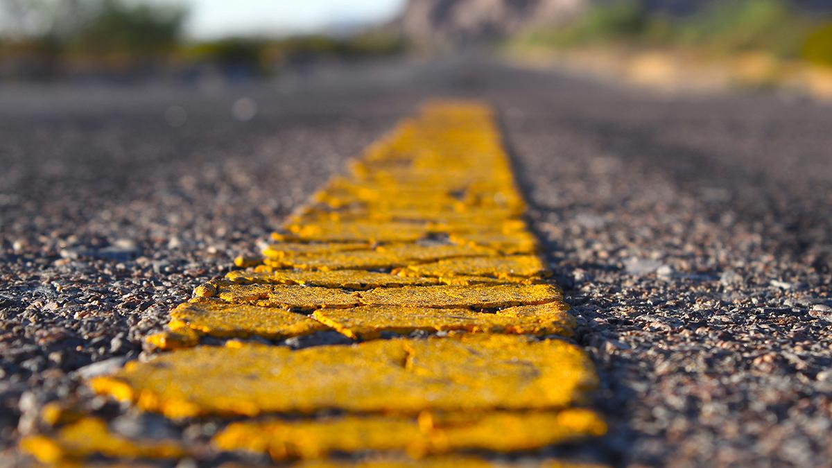 close up of yellow painted line on road