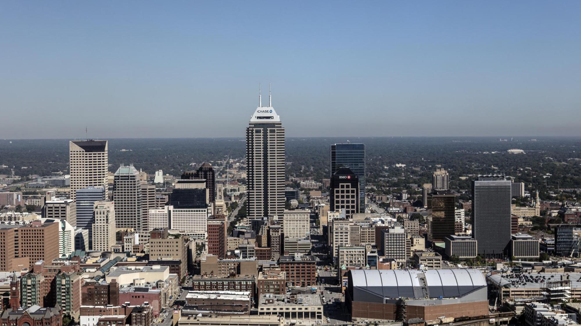 A few very tall buildings in the middle distance with shorter city buildings surrounding