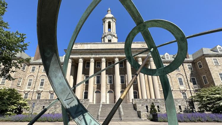 Wide shot of Old Main through Armillary Sphere