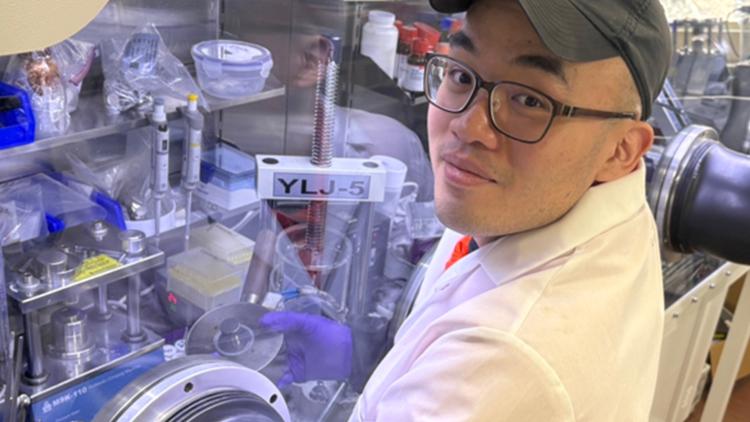 Person working in a lab with gloves in a chamber