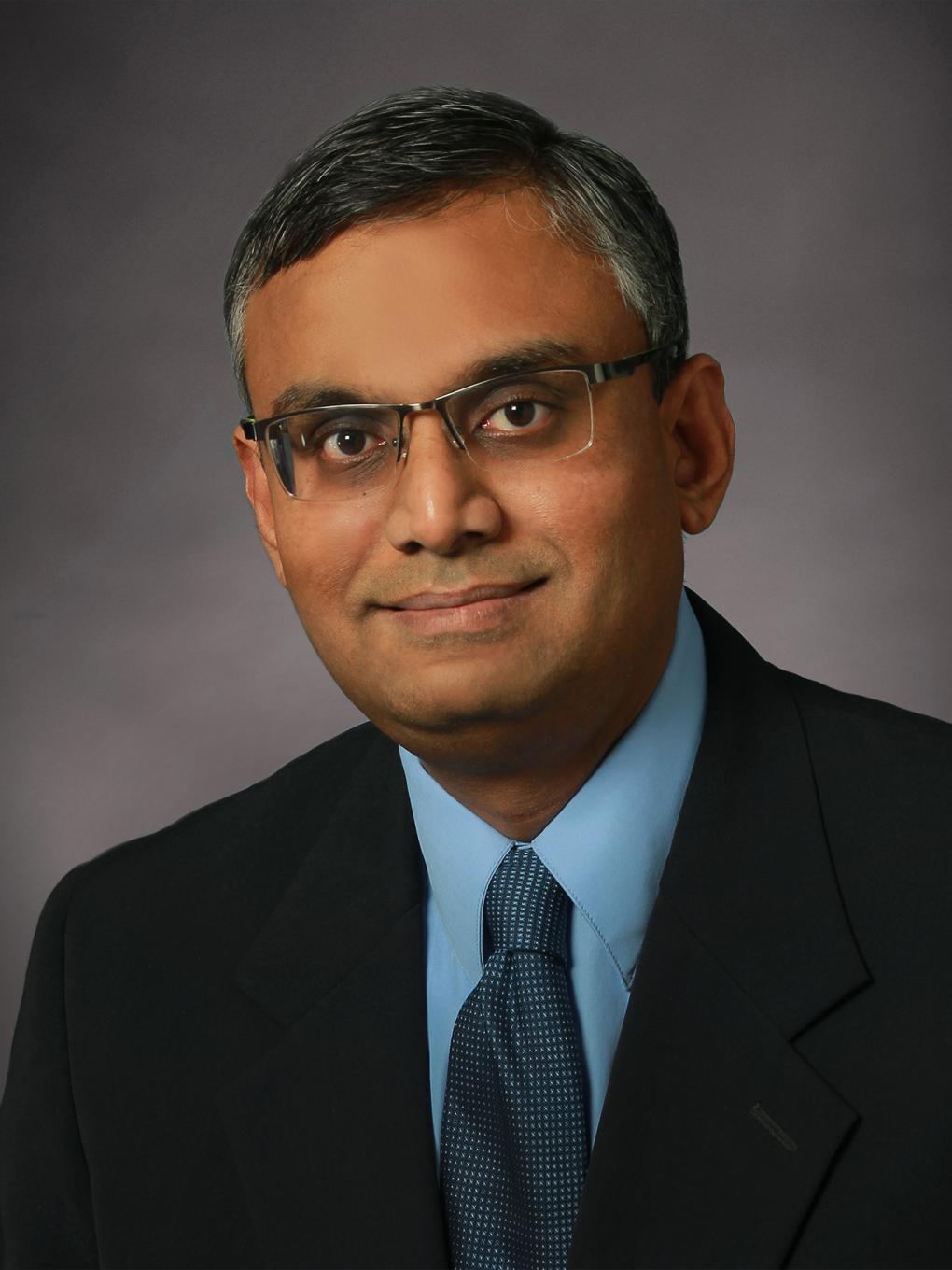 Headshot of man looking at camera.