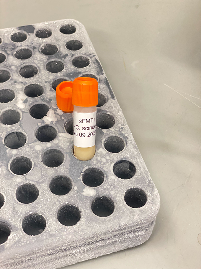 Vial with orange top in a vial rack