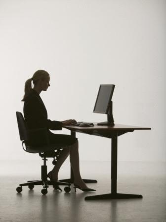 woman sitting at desk with computer