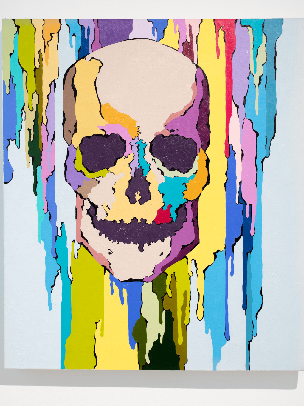 skull with rainbow colors of paint behind it